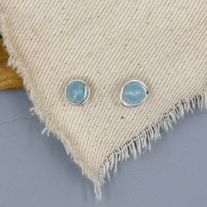 handmade aquamarine sterling silver stud earrings on white cloth