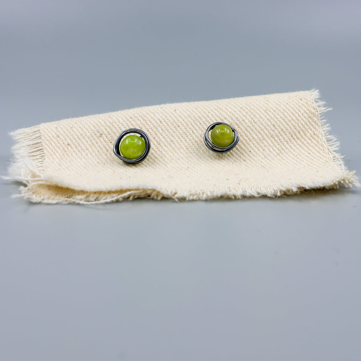 peridot stud earrings wire wrapped oxidized sterling silver detail view