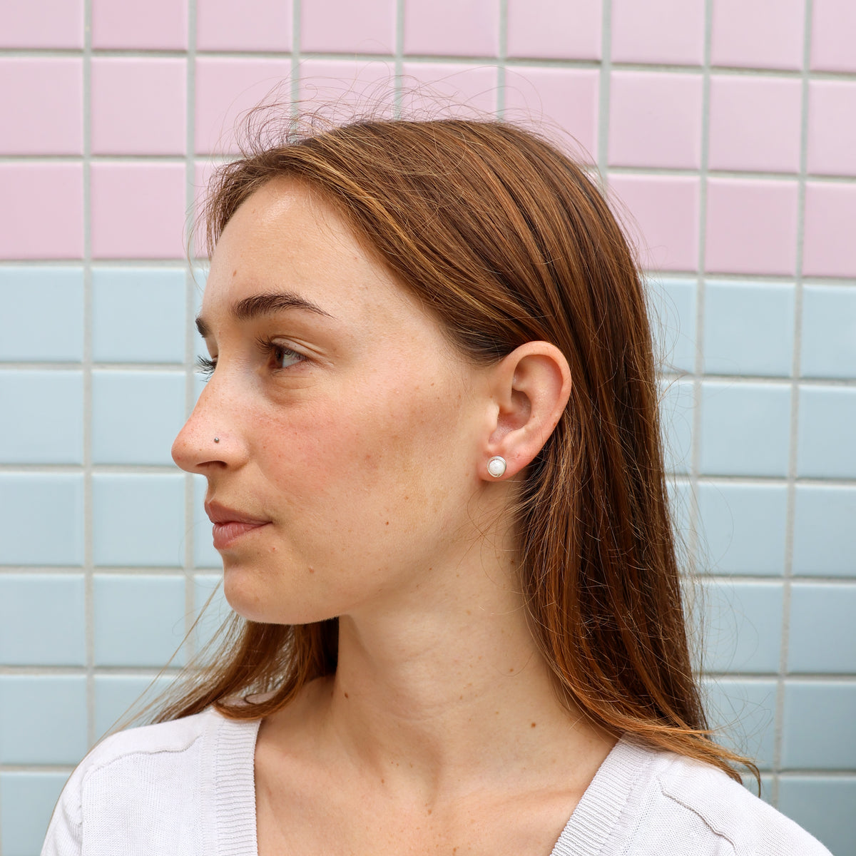 handmade sterling silver and moonstone wire wrap earrings worn on a model