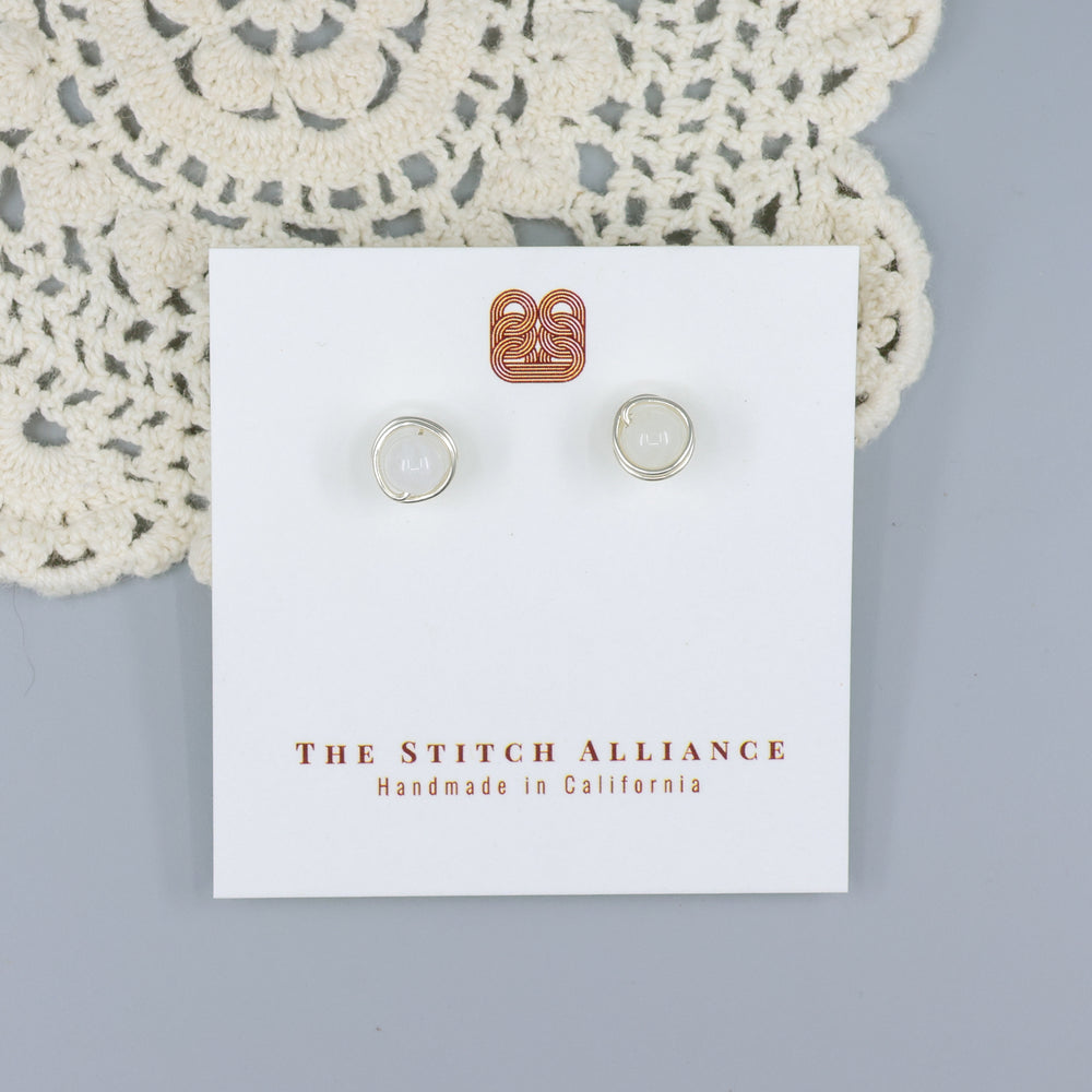 handmade moonstone and sterling silver wire wrapped stud earrings on a white card