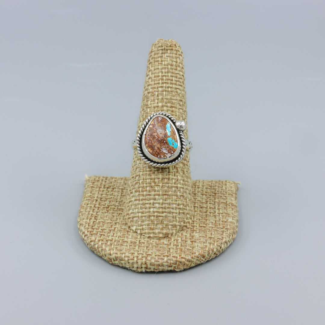 Nevada turquoose handmade one of a kind sterling silver ring on a linen display
