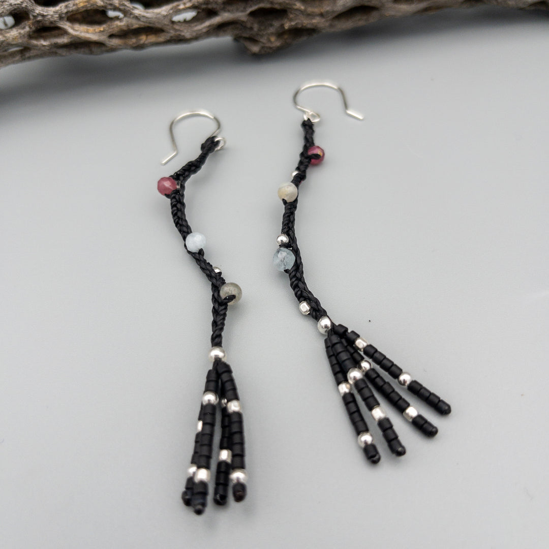 Night sky handcrafted earrings with pink tourmaline, aquamarine, labradorite, and sterling silver beads on a gray background