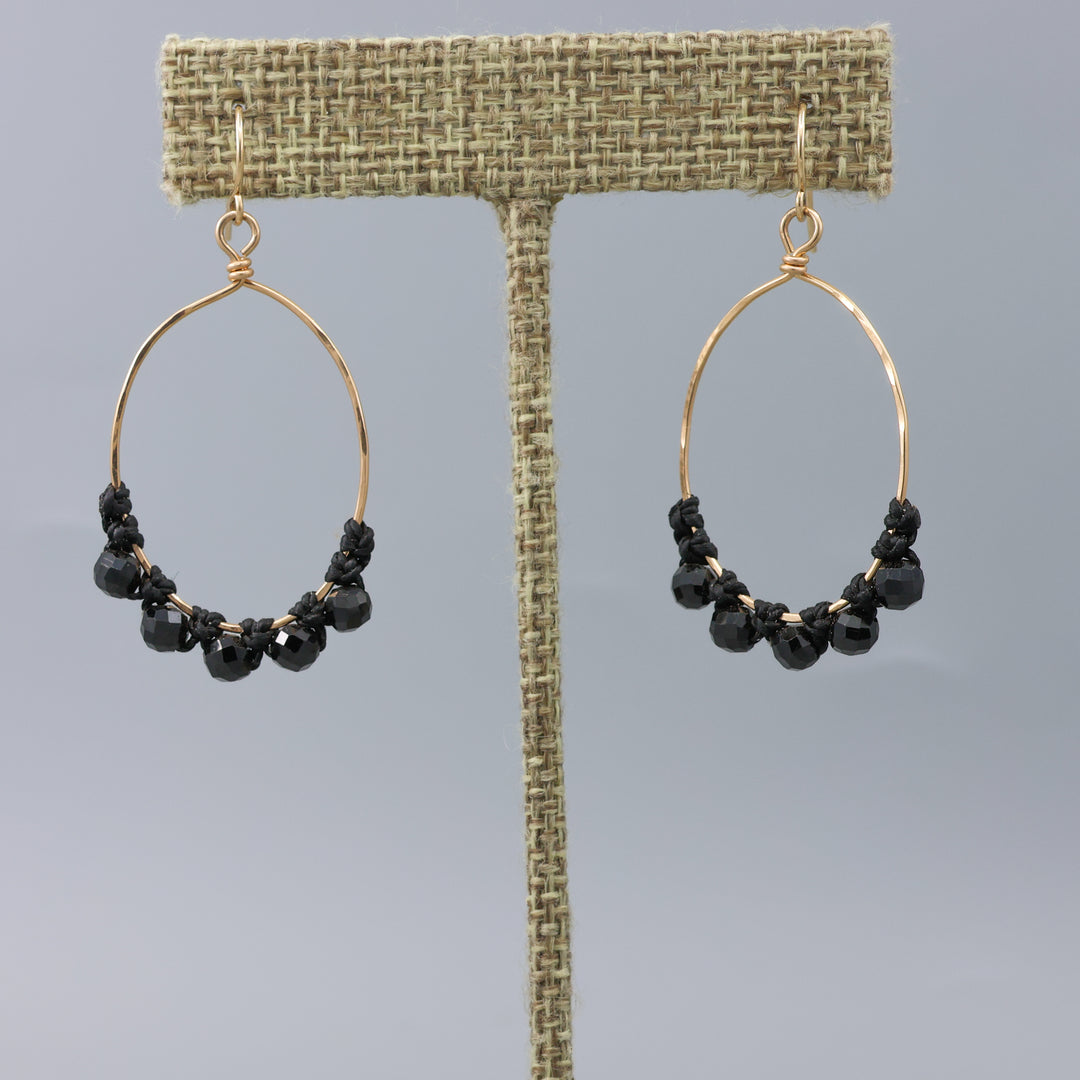 handmade gold hoops with black spinel beads and macrame