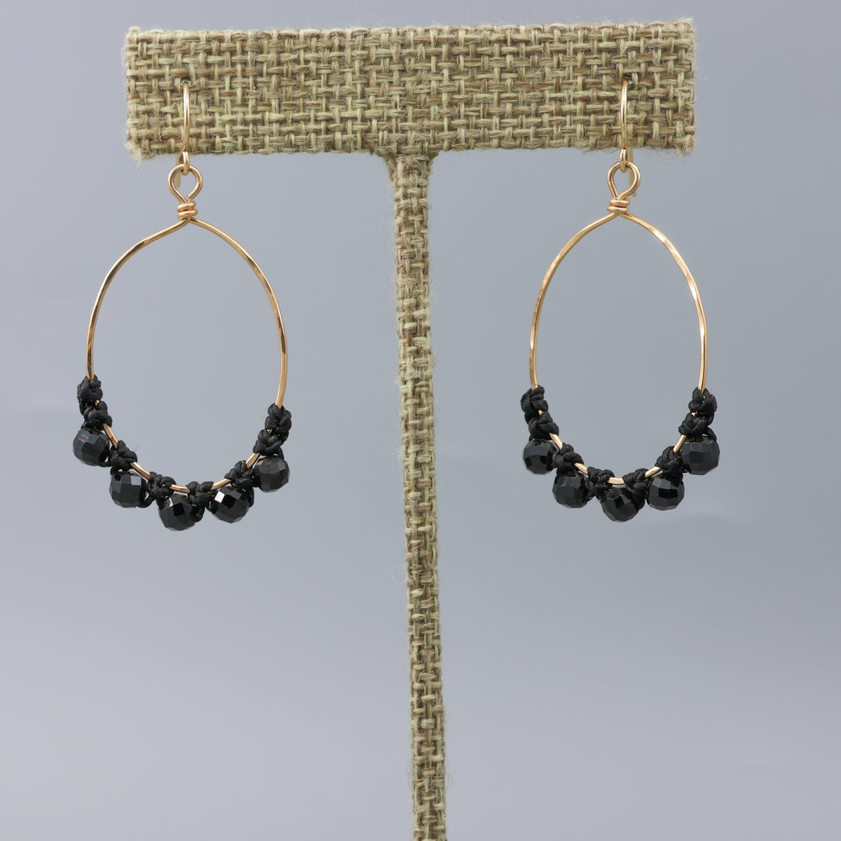 handmade gold hoops with black spinel beads and macrame