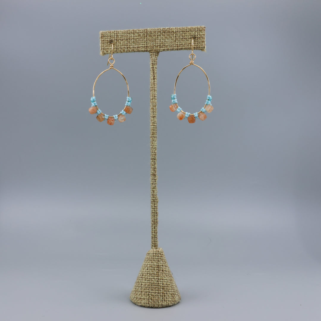 handmade sunstone and gold fill macrame earrings on a linen hanger