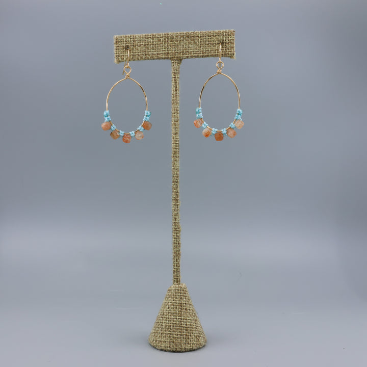 handmade sunstone and gold fill macrame earrings on a linen hanger