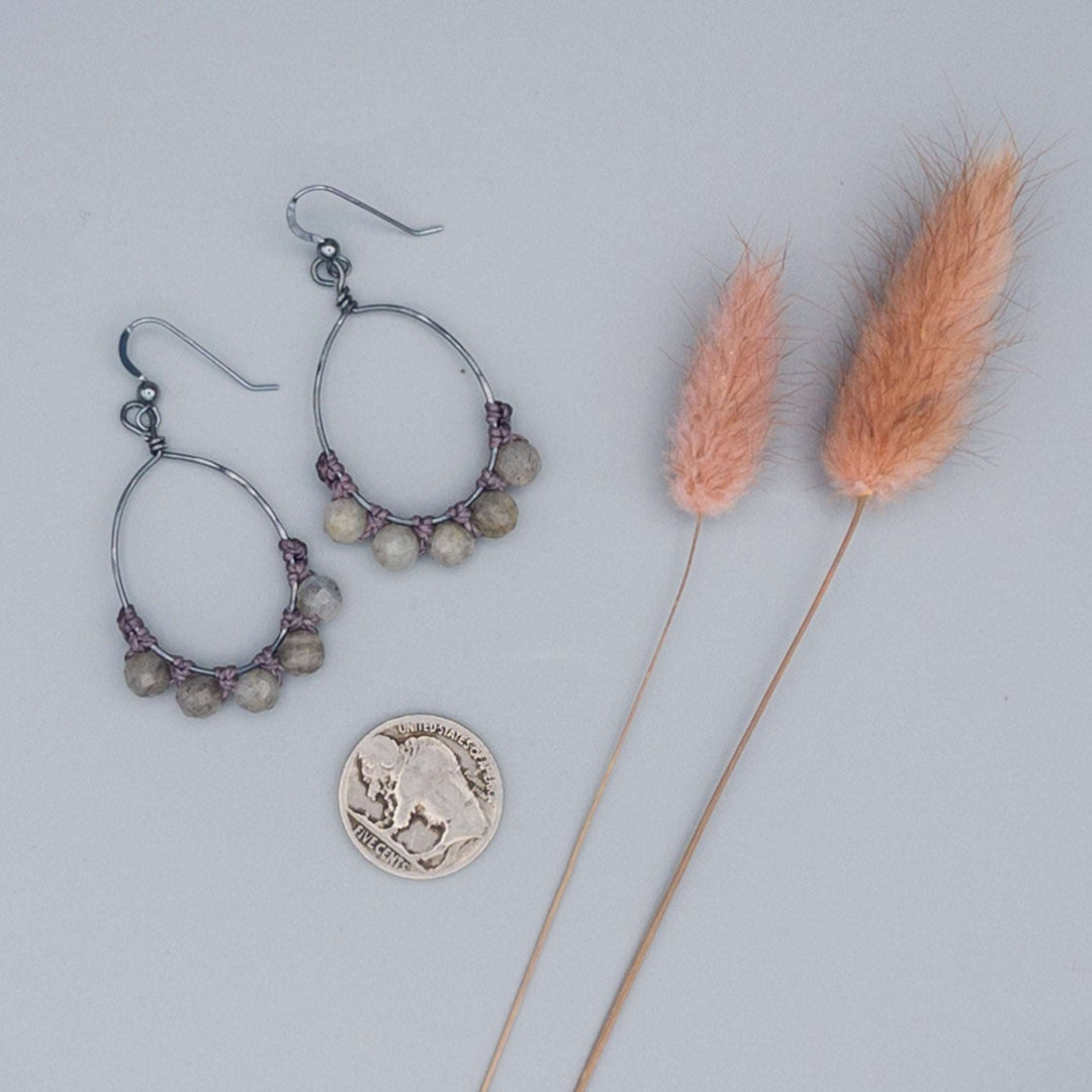 oxidized sterling silver oval hoop earrings with labradorite beads shown with a buffalo nickel for size comparison