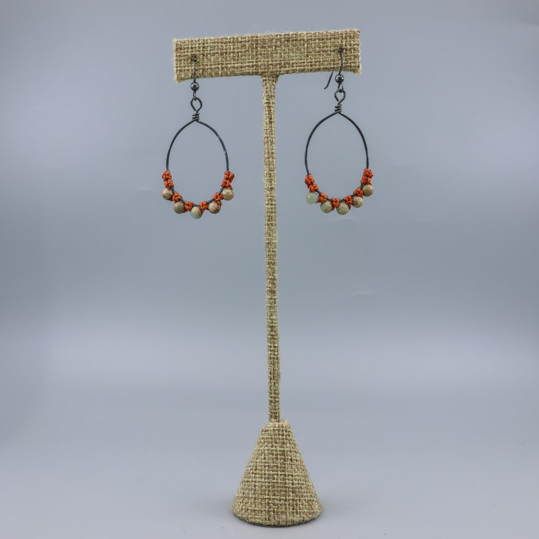 handmade aqua terra jasper beaded hoop earrings on a linen hanger