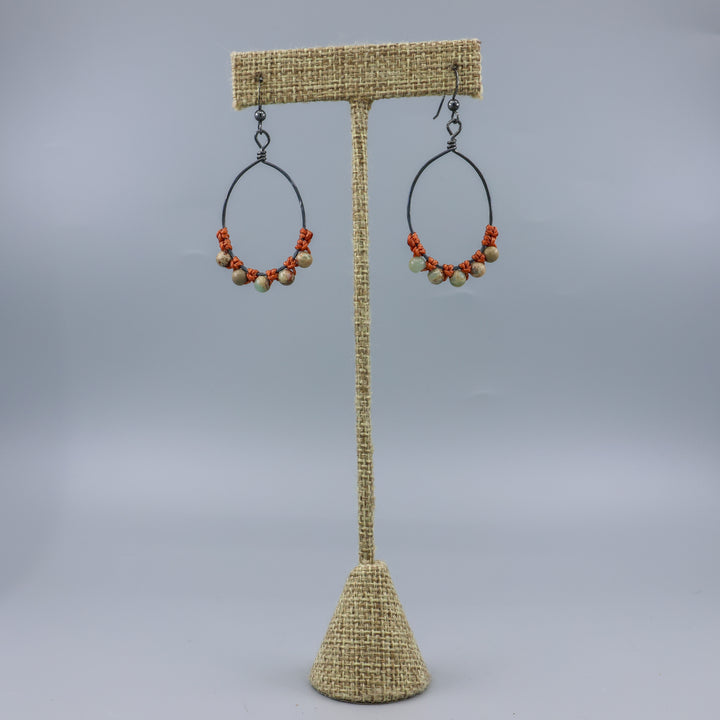 handmade aqua terra jasper beaded hoop earrings on a linen hanger