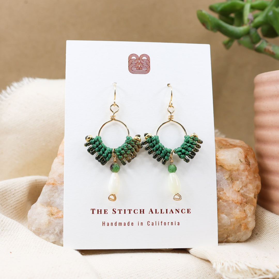 mother of pearl and ruby in zoisite gold filled hoop earrings on a white card