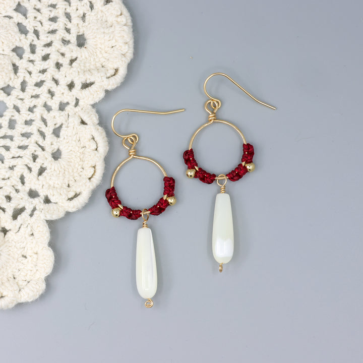 handmade gold hoops with mother of pearl beads and red macrame