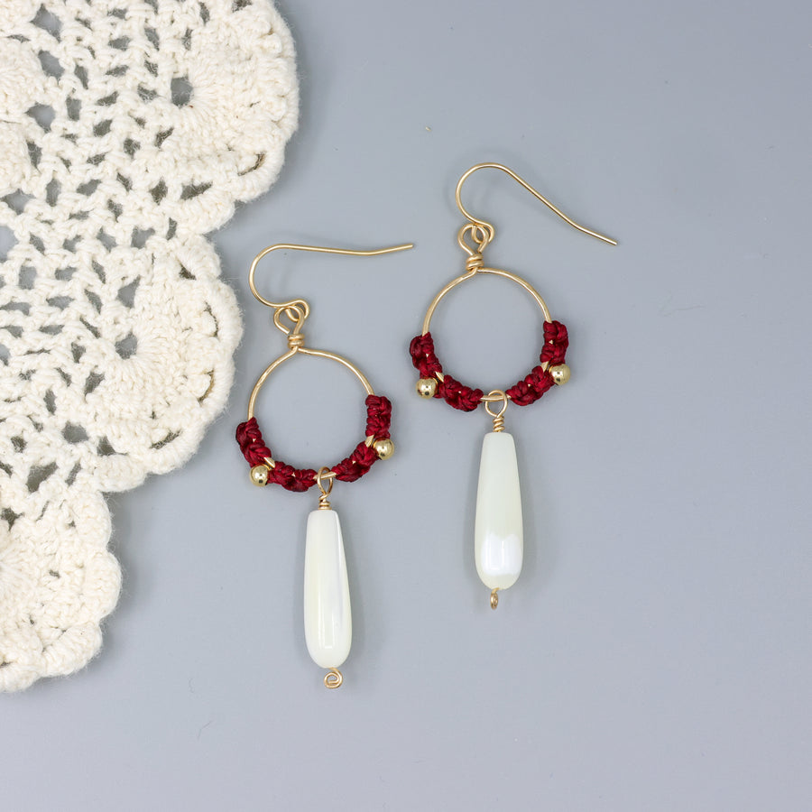 handmade gold hoops with mother of pearl beads and red macrame