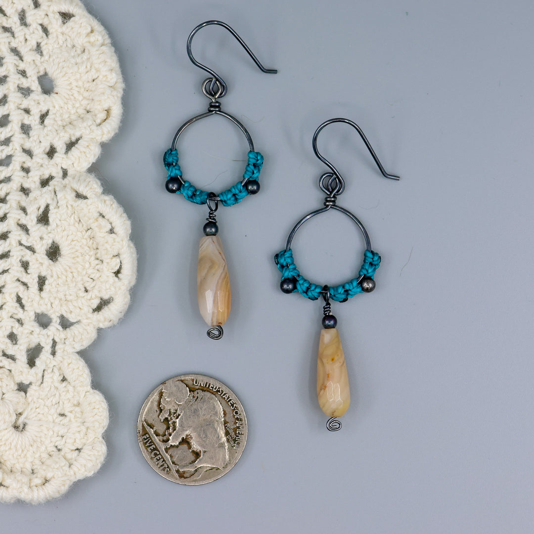 handmade macrame hoop earrings in oxidized sterling silver with botswana agate beads with a nickel for size comparison
