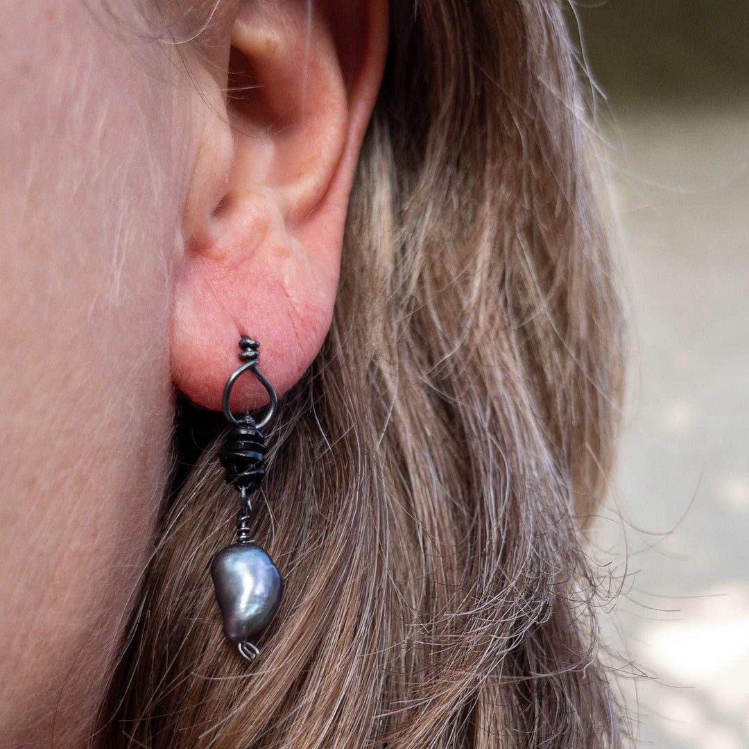 Freshwater pearl drop earrings oxidized sterling silver and black leather on model