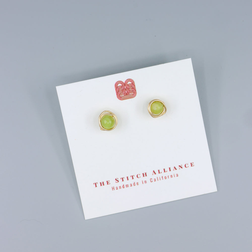 handmade peridot stud earrings 14k gold fill on a white card