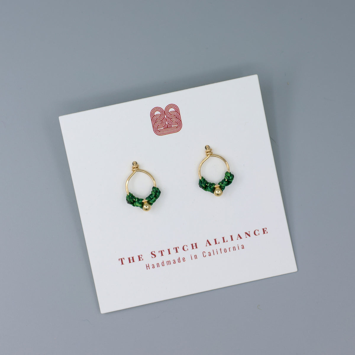 handmade gold filled minialist macrame earrings green on a white card
