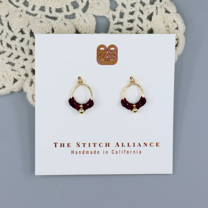 handmade small, gold-filled macrame stud earrings on a white card
