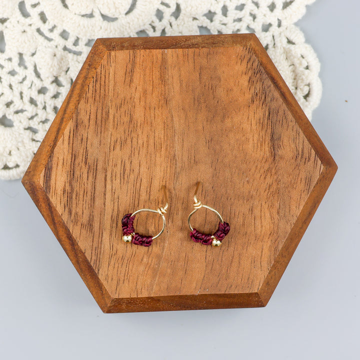 handmade small, gold-filled macrame stud earrings overhead view