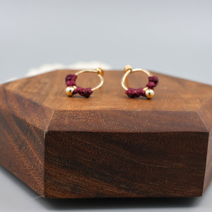 small, gold-filled macrame stud earrings close up