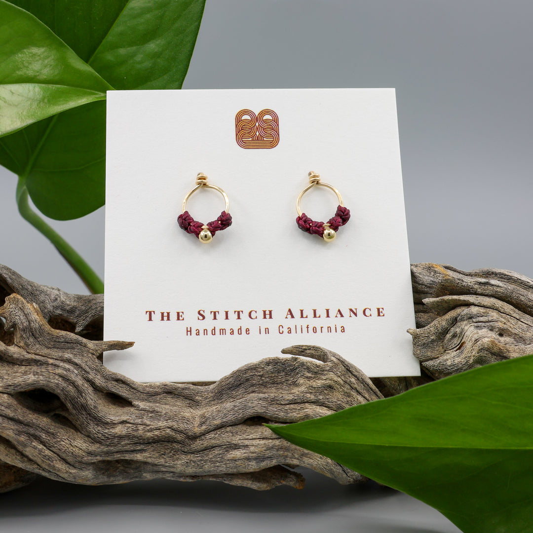 small, gold-filled macrame stud earrings on a white card