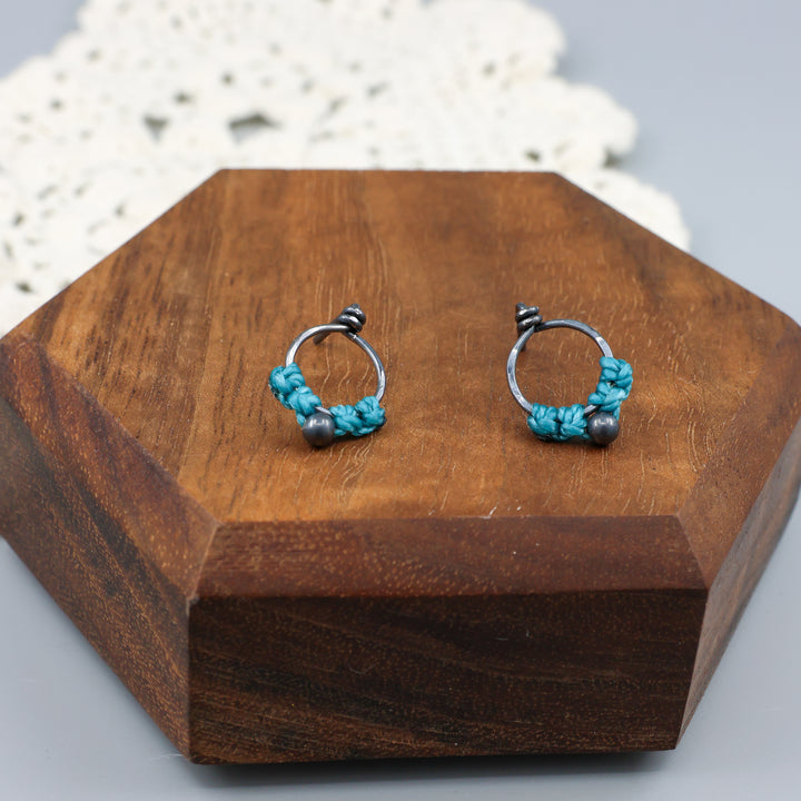 small, oxidized sterling silver macrame stud earrings in turquoise close up view