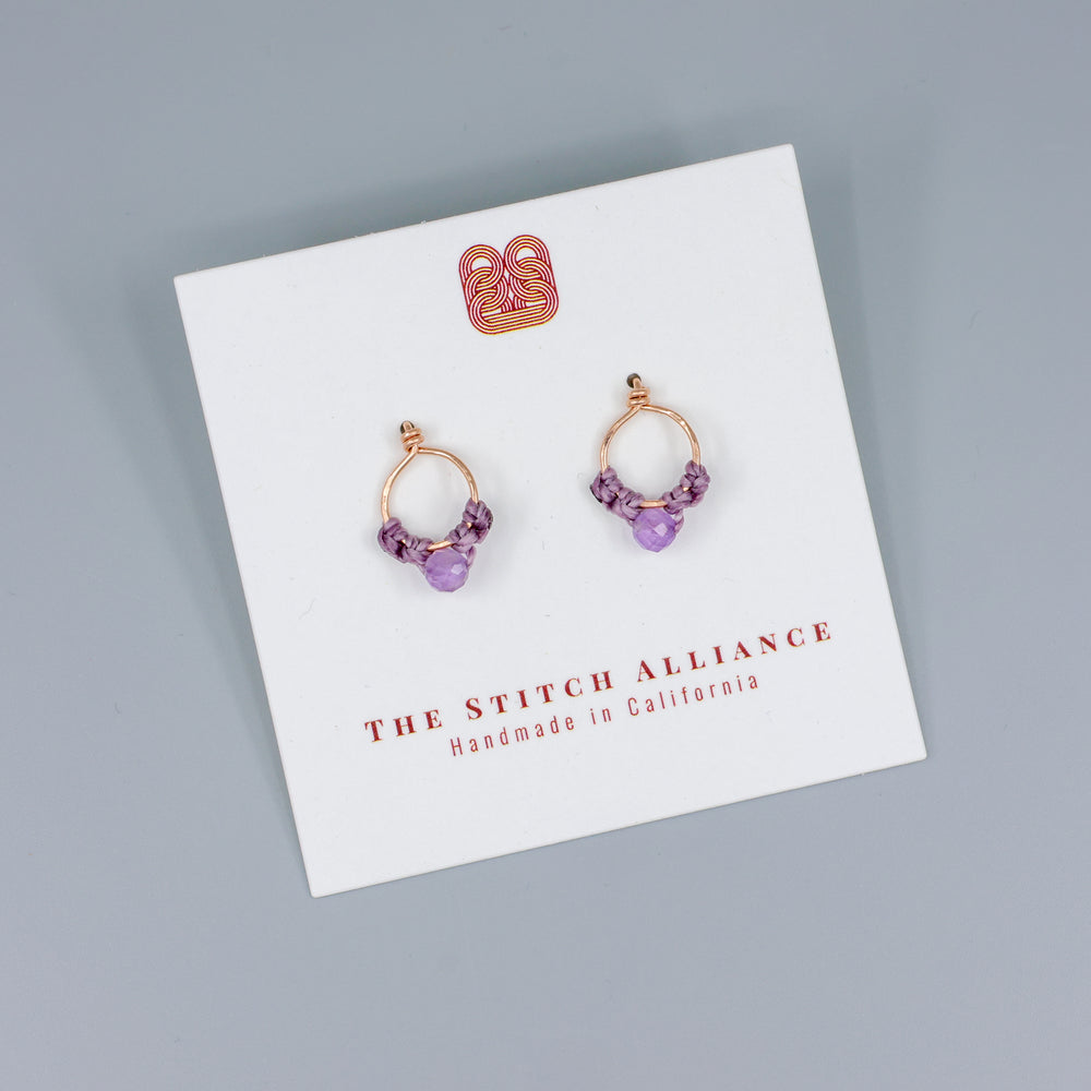 handmade rose gold macrame stud earrings with amethyst beads on a white card