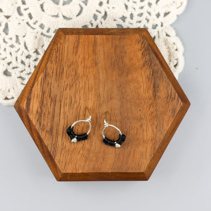 handmade sterling silver macrame stud earrings on a wood block