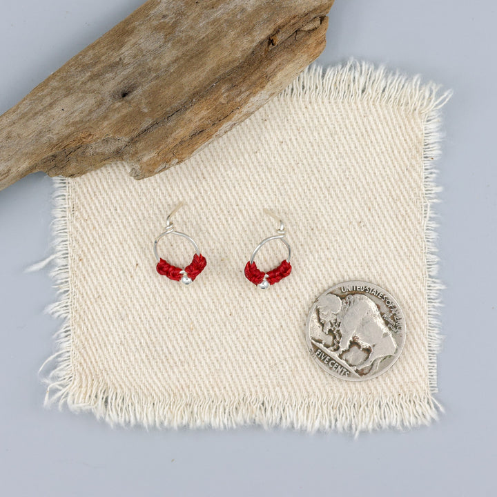 handmade sterling silver red macrame earrings with a nickel for size comparison