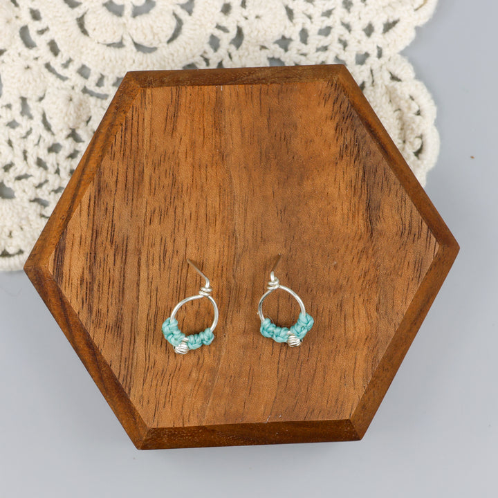 sterling silver macrame earrings aqua blue on a wood block