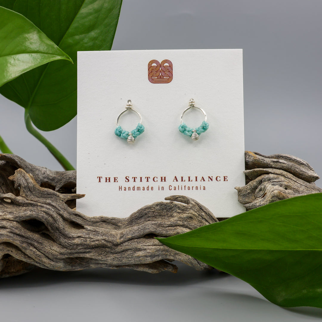 sterling silver macrame earrings aqua blue on a white card with gray background