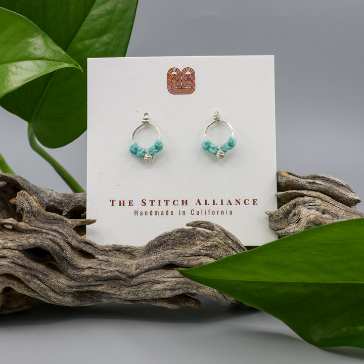 sterling silver macrame earrings aqua blue on a white card with gray background