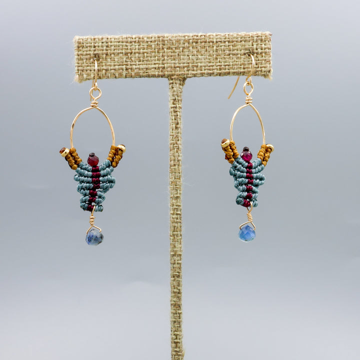 handmade macrame earrings with kyanite and garnet beads in 14k gold fill on a linen hanger