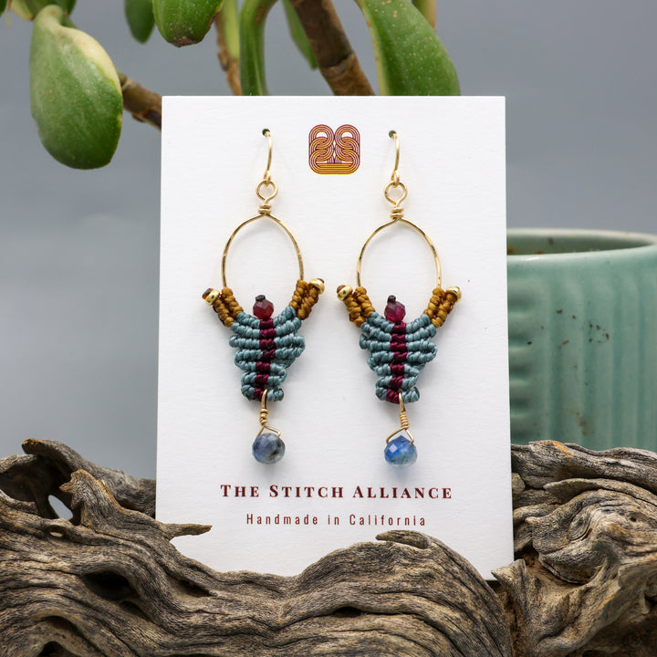 handmade macrame earrings with kyanite and garnet beads in 14k gold fill on a white display card
