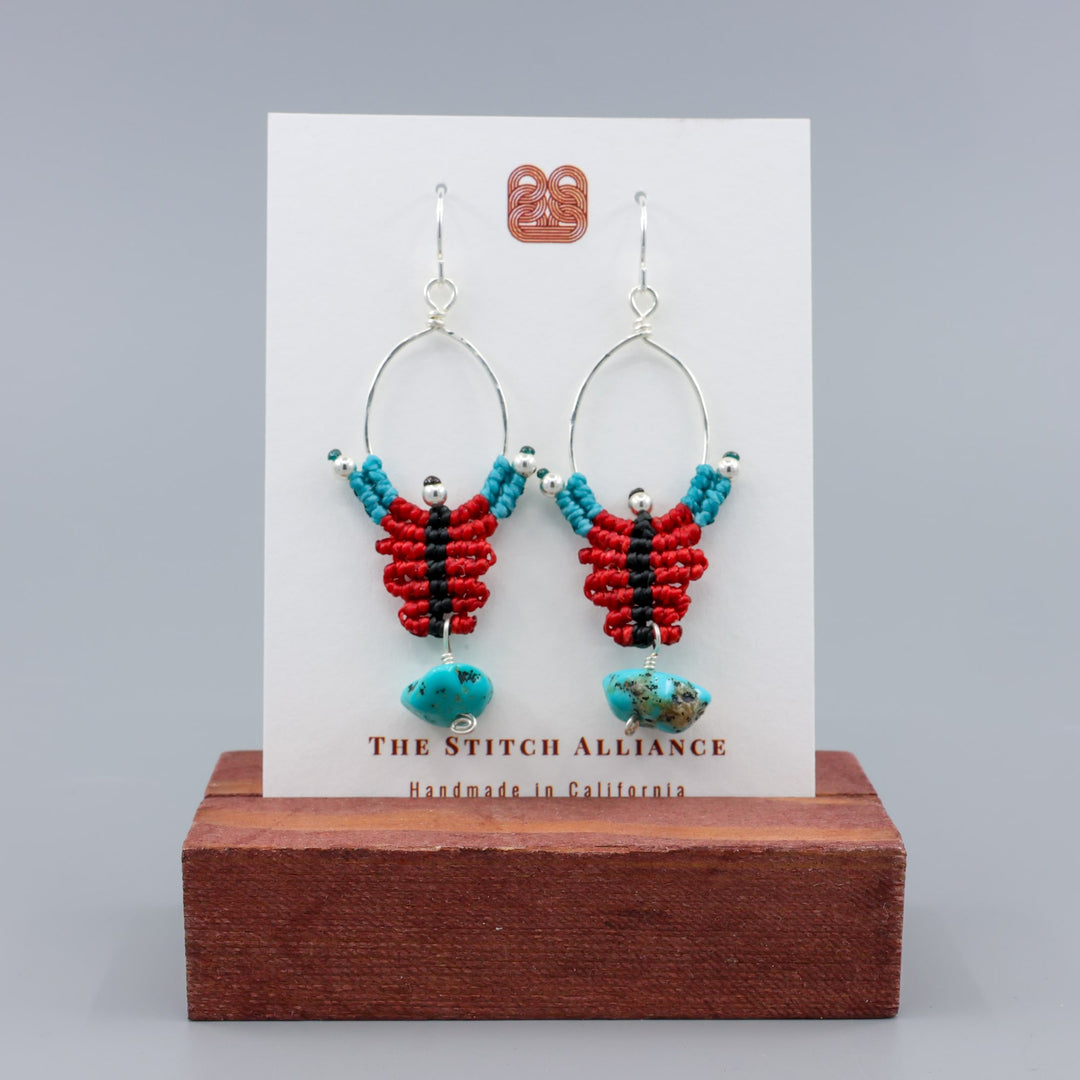 red, black, turquoise sterling silver macrame earrings with turquoise bead on a wihte card