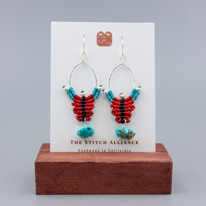 red, black, turquoise sterling silver macrame earrings with turquoise bead on a wihte card