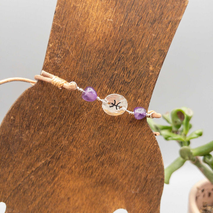 Pisces bracelet with amethyst beads. Hand stamped sterling silver and natural leather. 