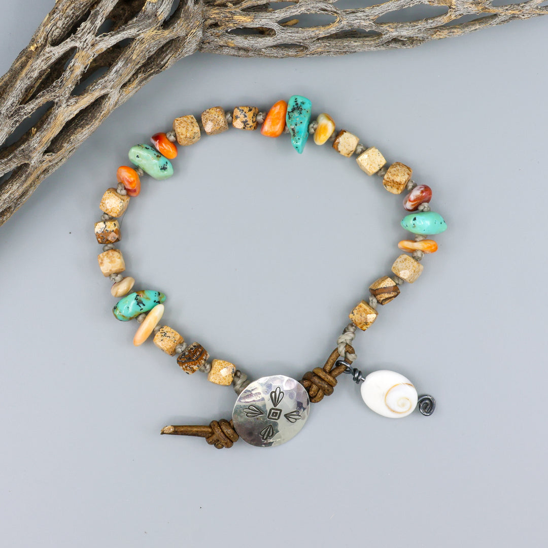 Overhead view of Picture Jasper, Turquoise, and Spiny Oyster handmade bracelet with leather and sterling silver button closure