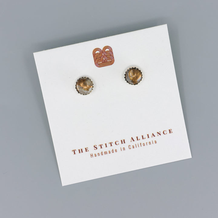 Handmade, copper calcite stud earrings in sterling silver on a gray backbround