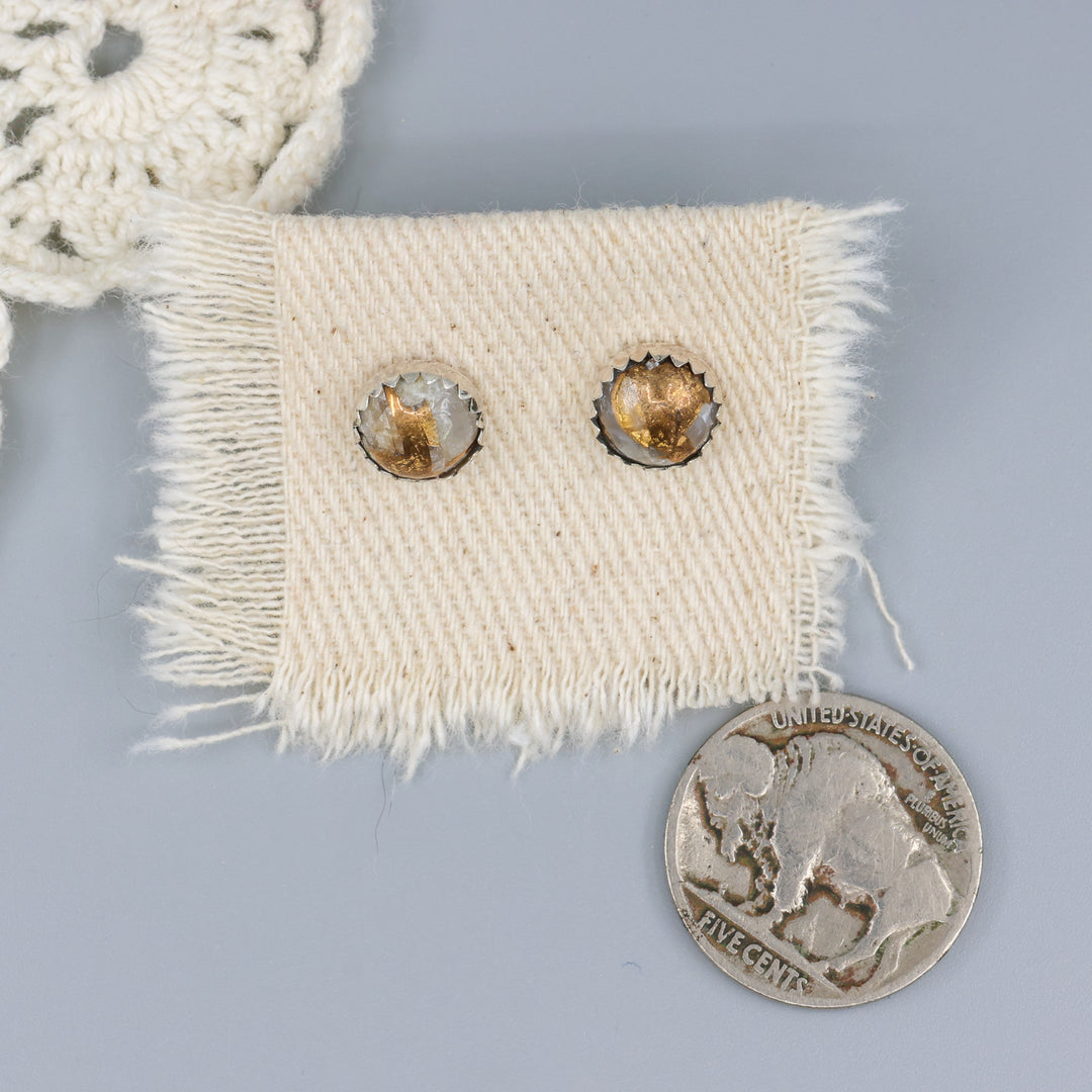 Handmade, copper calcite stud earrings in sterling silver with a nickel for size comparison