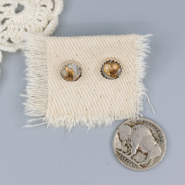Handmade, copper calcite stud earrings in sterling silver with a nickel for size comparison