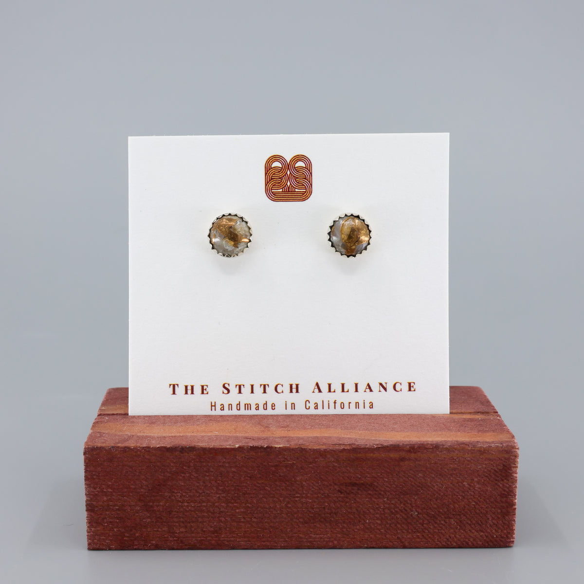 Handmade, copper calcite stud earrings in sterling silver on a white card