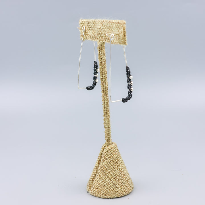 back view of handmade sterling silver rectangle hoops with macrame detail