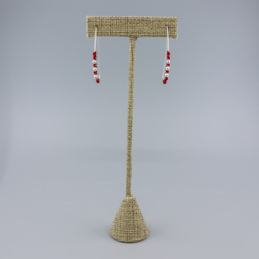 handmade sterling silver red macrame hoop earrings on a linen hanger