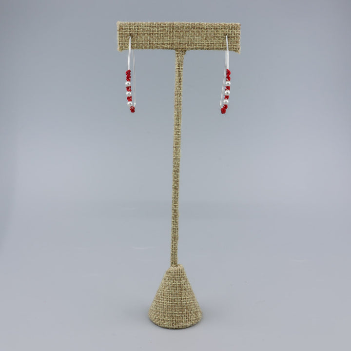 handmade sterling silver red macrame hoop earrings on a linen hanger