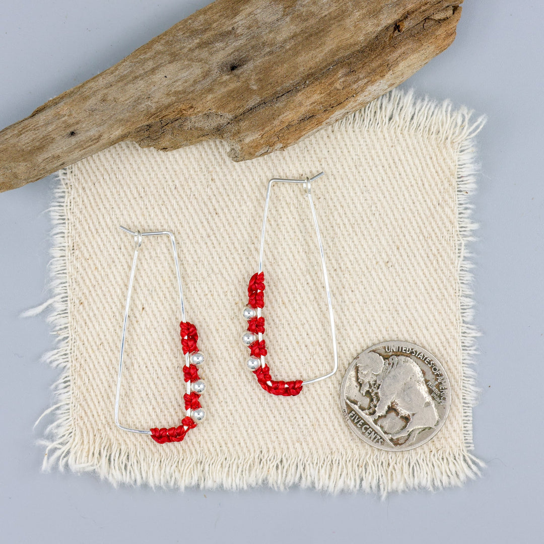 handmade sterling silver red macrame hoop earrings with a nickel for size comparison