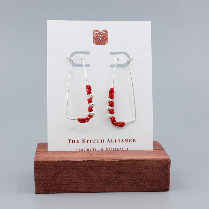 handmade sterling silver red macrame hoop earrings on a white card