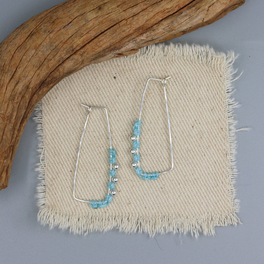 handmade sterling silver macrame rectangle hoop earrings in aqua on a white background