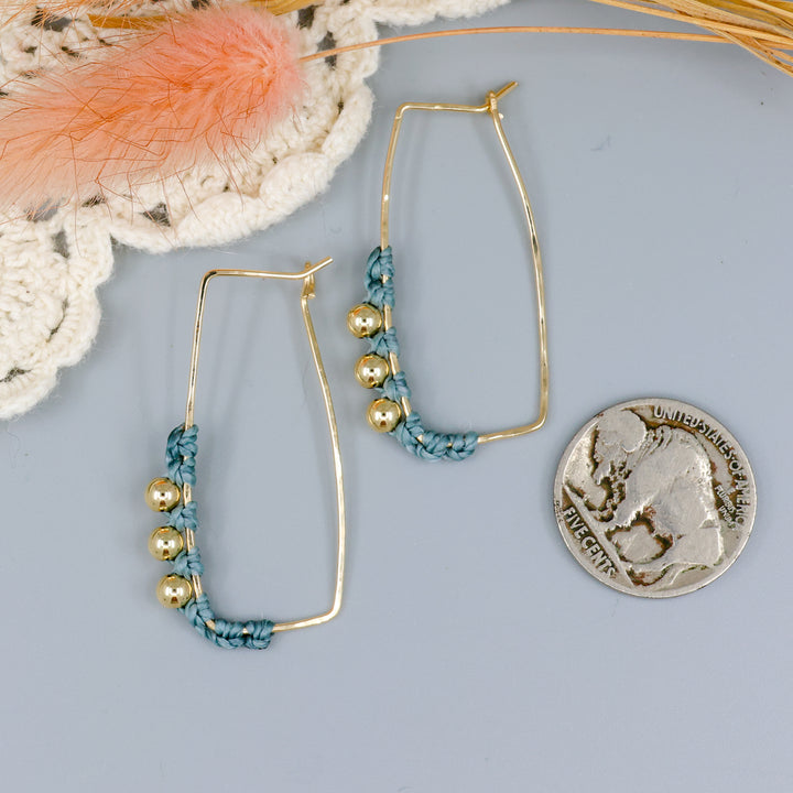 gold fill rectangle hoop earrings with macrame details with nickel for size comparison