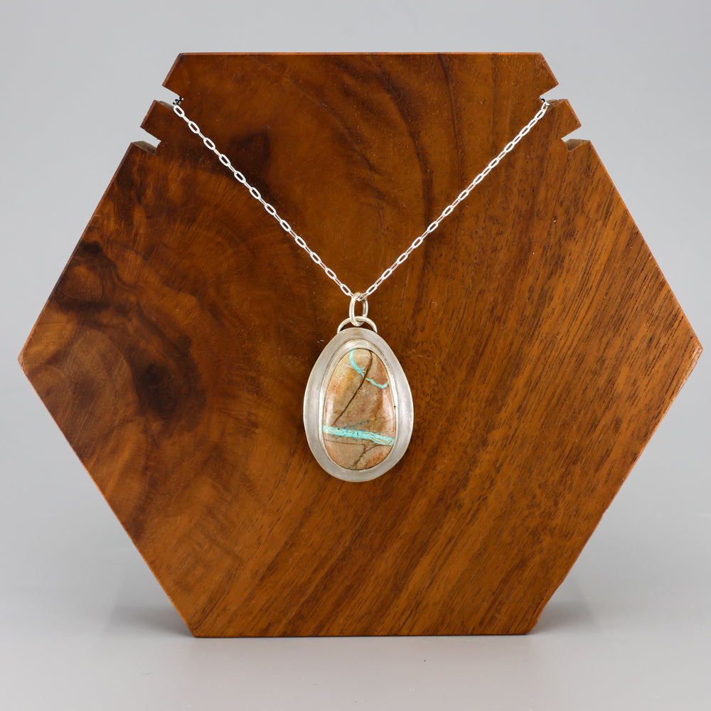 handmade ribbon turquoise oval shaped pendant necklace OOAK on a wood display