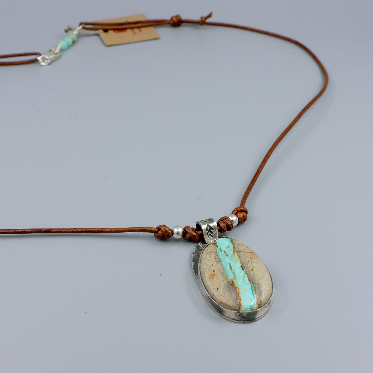 Ribbon turquoise sterling silver pendant on leather cord detail view